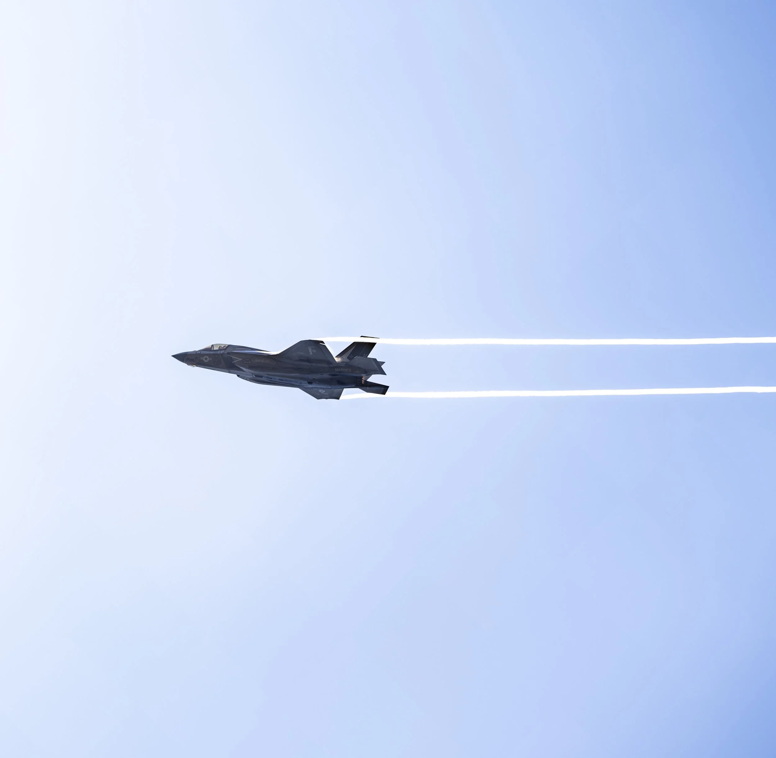 An F-35 Lightning II streaks across the Washington sky with afterburners engaged during the America 250 military aviation demonstration.