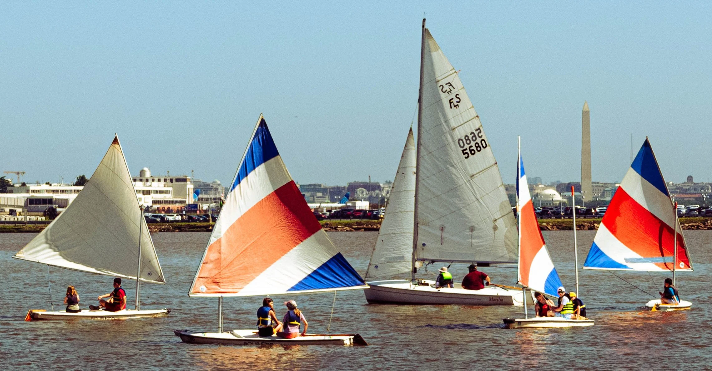 Youth sailors maneuver training boats during a sailing lesson on the Potomac River in Washington, D.C.