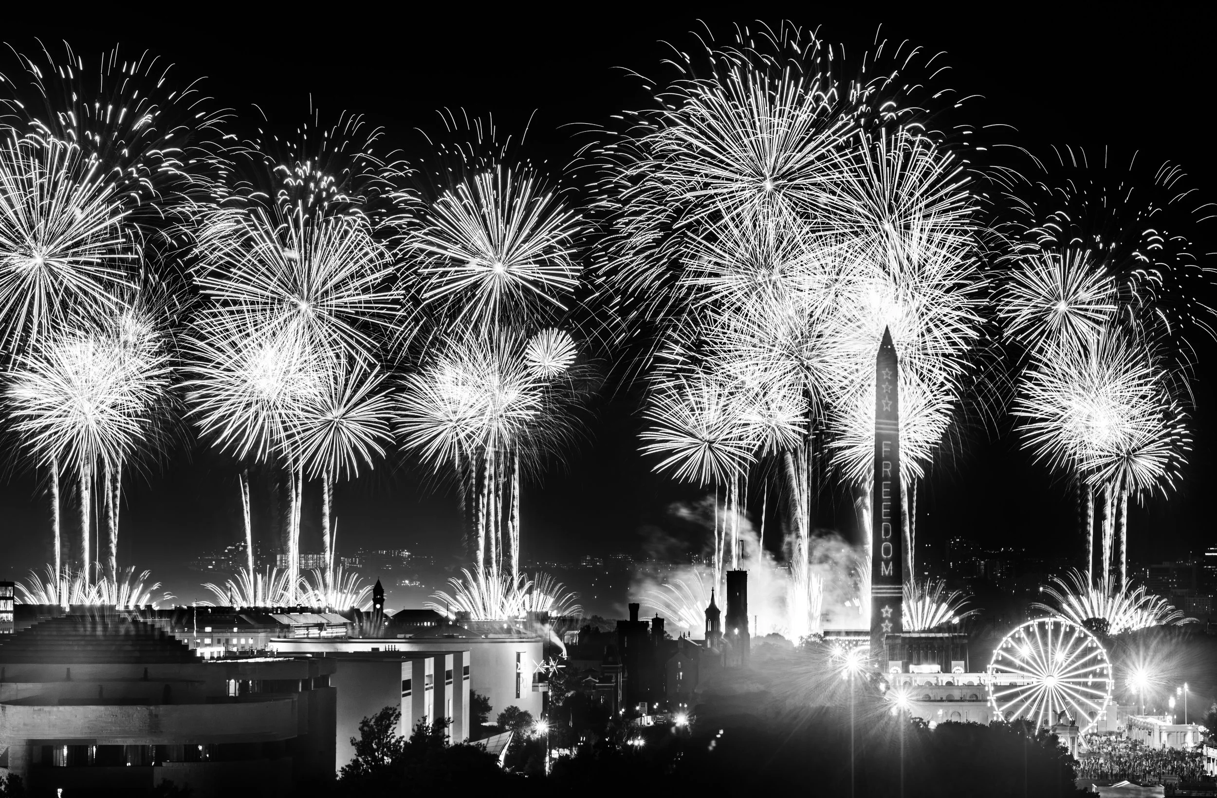 A monochrome interpretation of the America 250 fireworks emphasizes dramatic contrast, highlighting the Washington Monument beneath brilliant fireworks exploding across the sky.