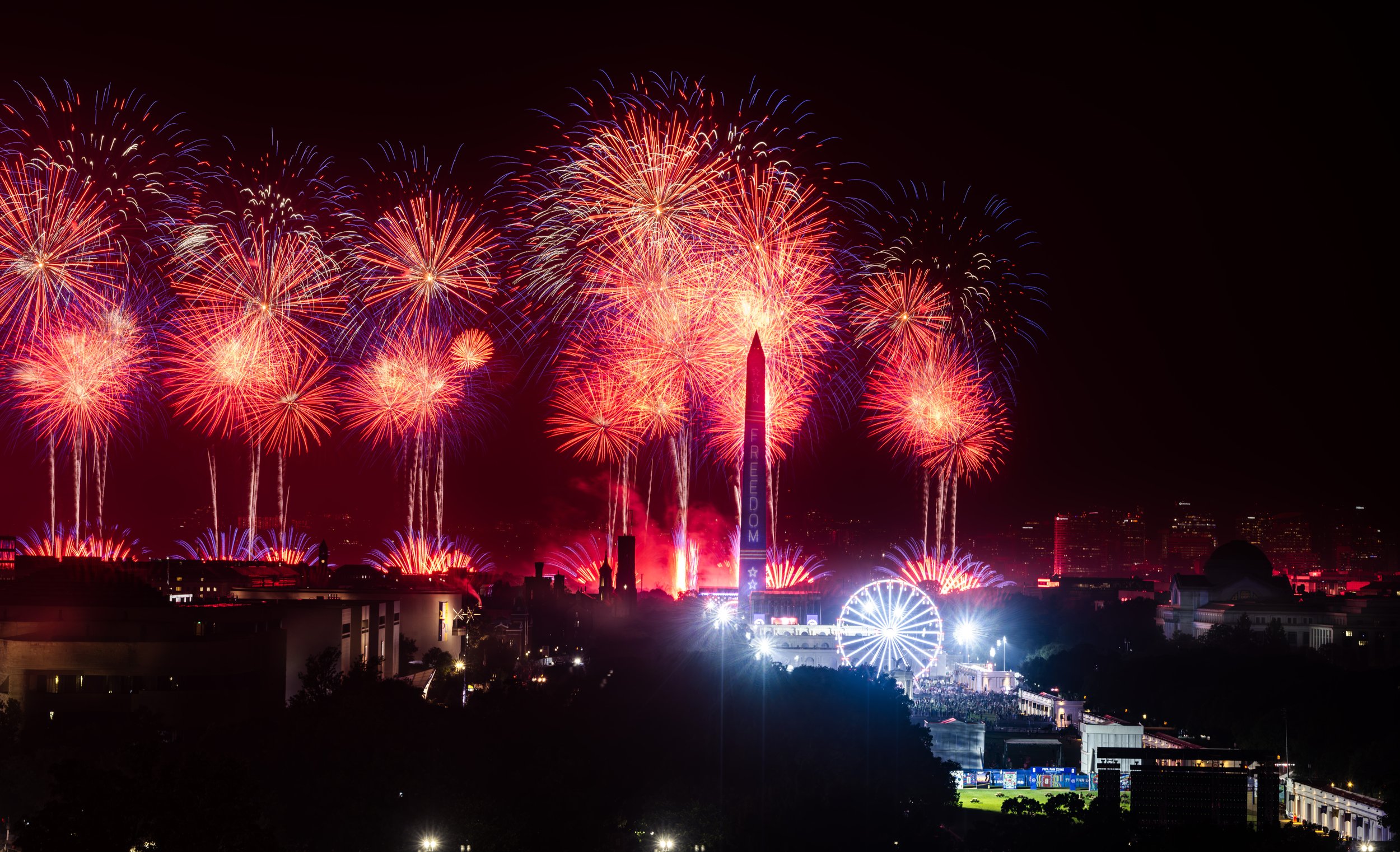 Brilliant fireworks erupt around the Washington Monument during the America 250 celebration, creating a vibrant patriotic display over the nation's capital.