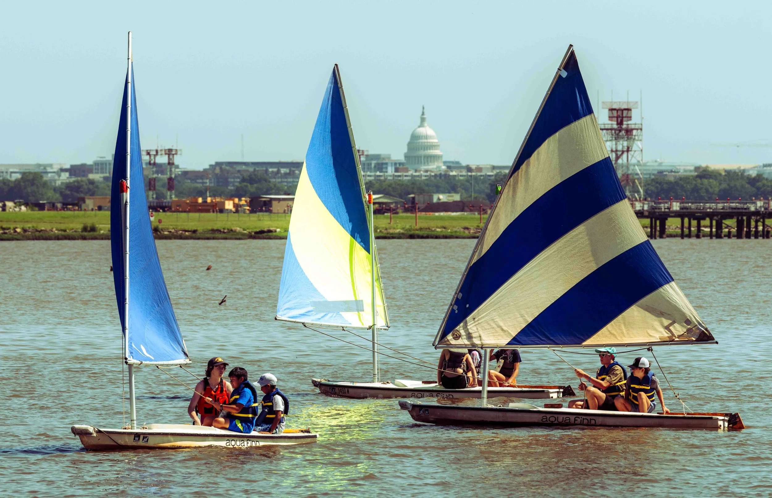 Youth sailors maneuver training boats during a sailing lesson on the Potomac River in Washington, D.C.
