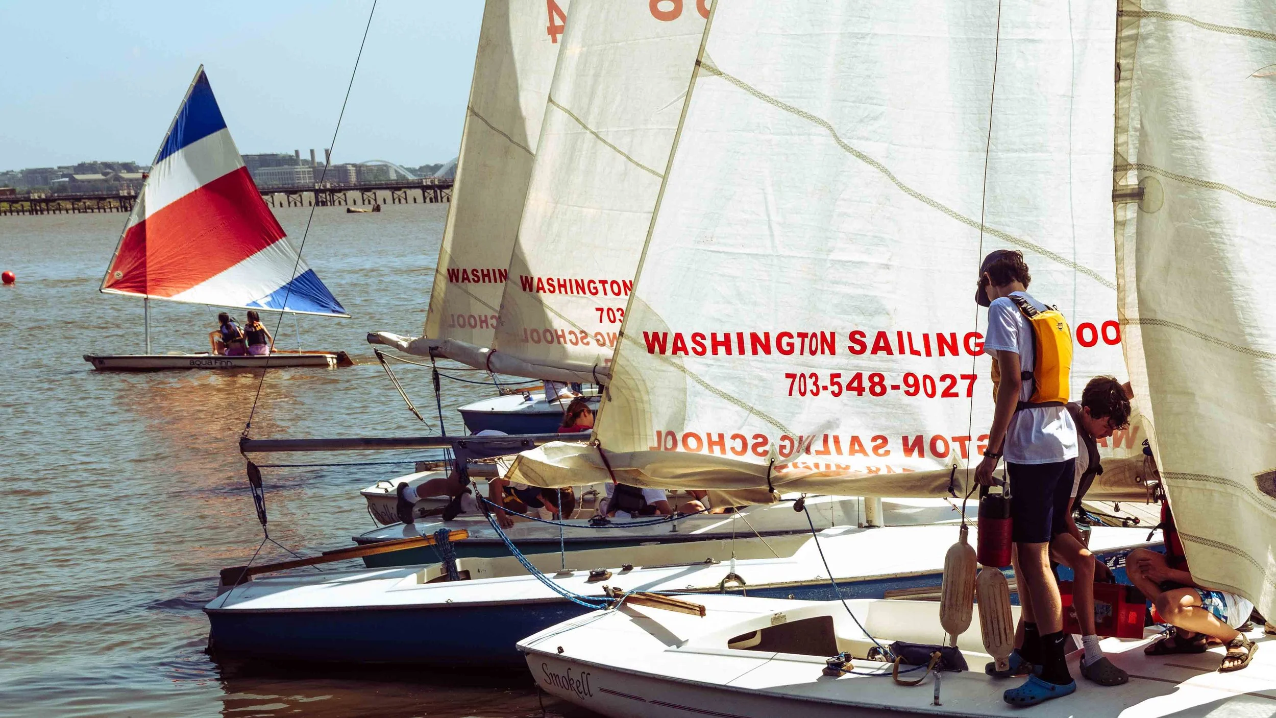 Sailing students work together to navigate changing wind conditions during on-water instruction.