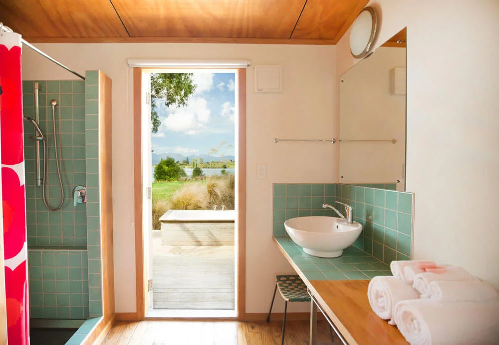 Bathroom interior with door to the outdoor bath and deck