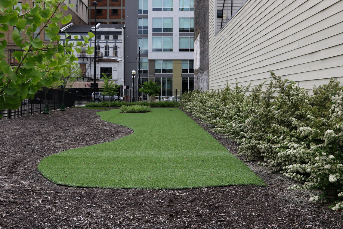 As of this writing, the former location of the Dennison is still occupied by greenery, mulch, and an astro-turf surface akin to a miniature golf course.