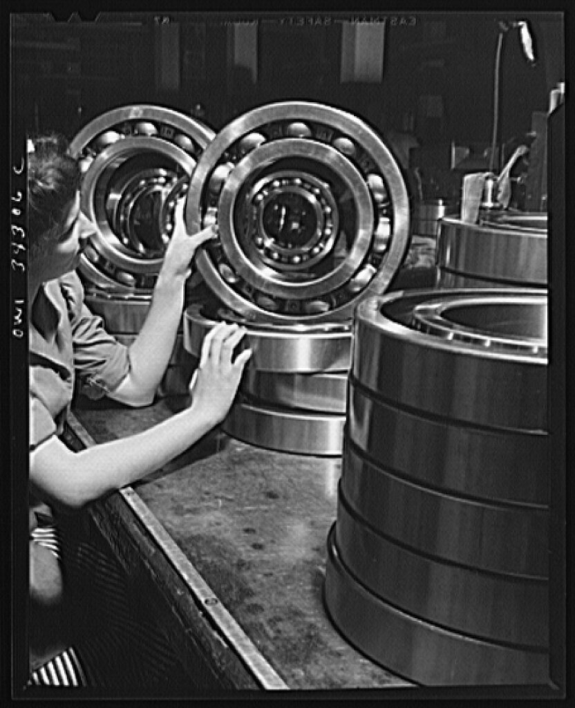 An inspector at the Fafnir Bearing Company inspecting large roller bearing.jpg