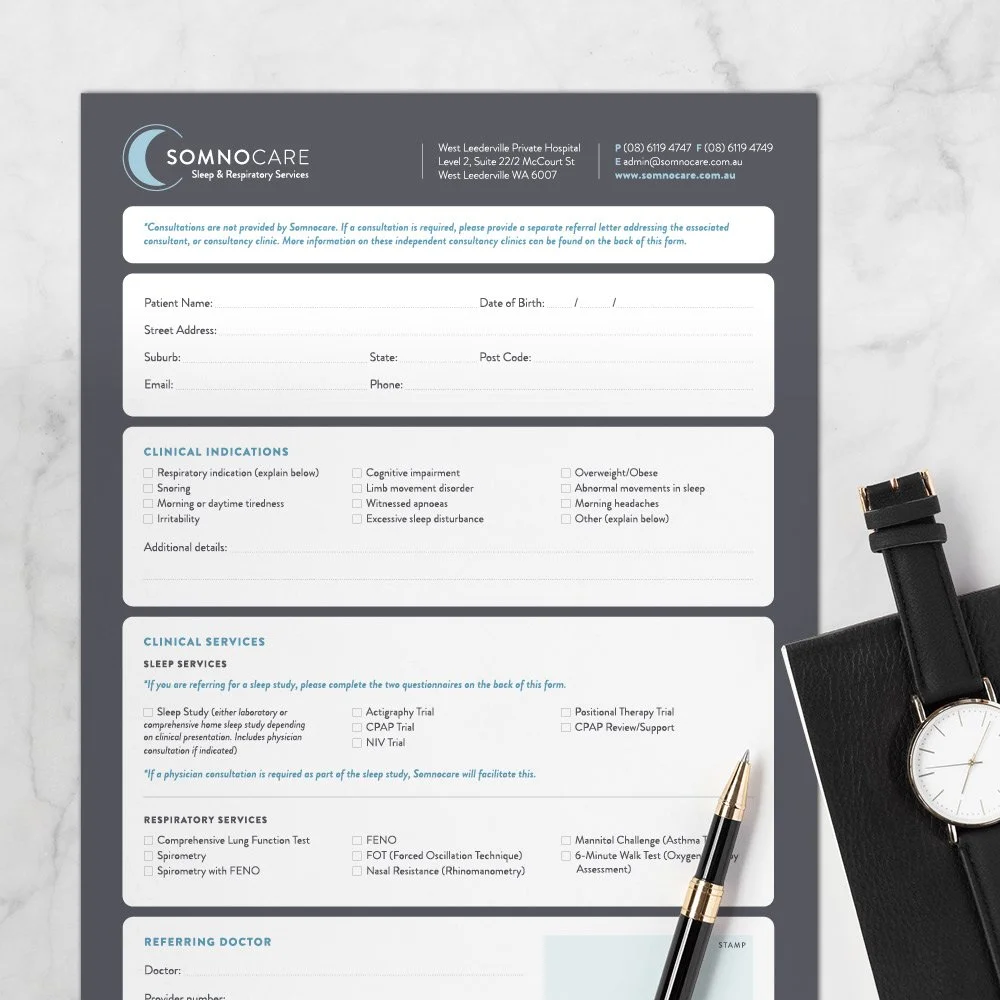 Somnocare referral form on marble benchtop next to pen notebook and watch.