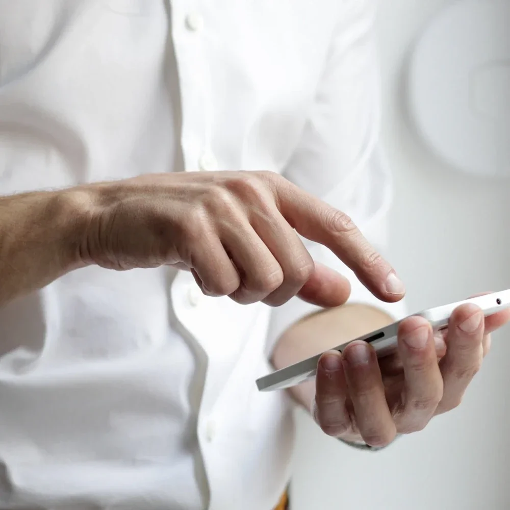 Close up of mans hands using mobile phone