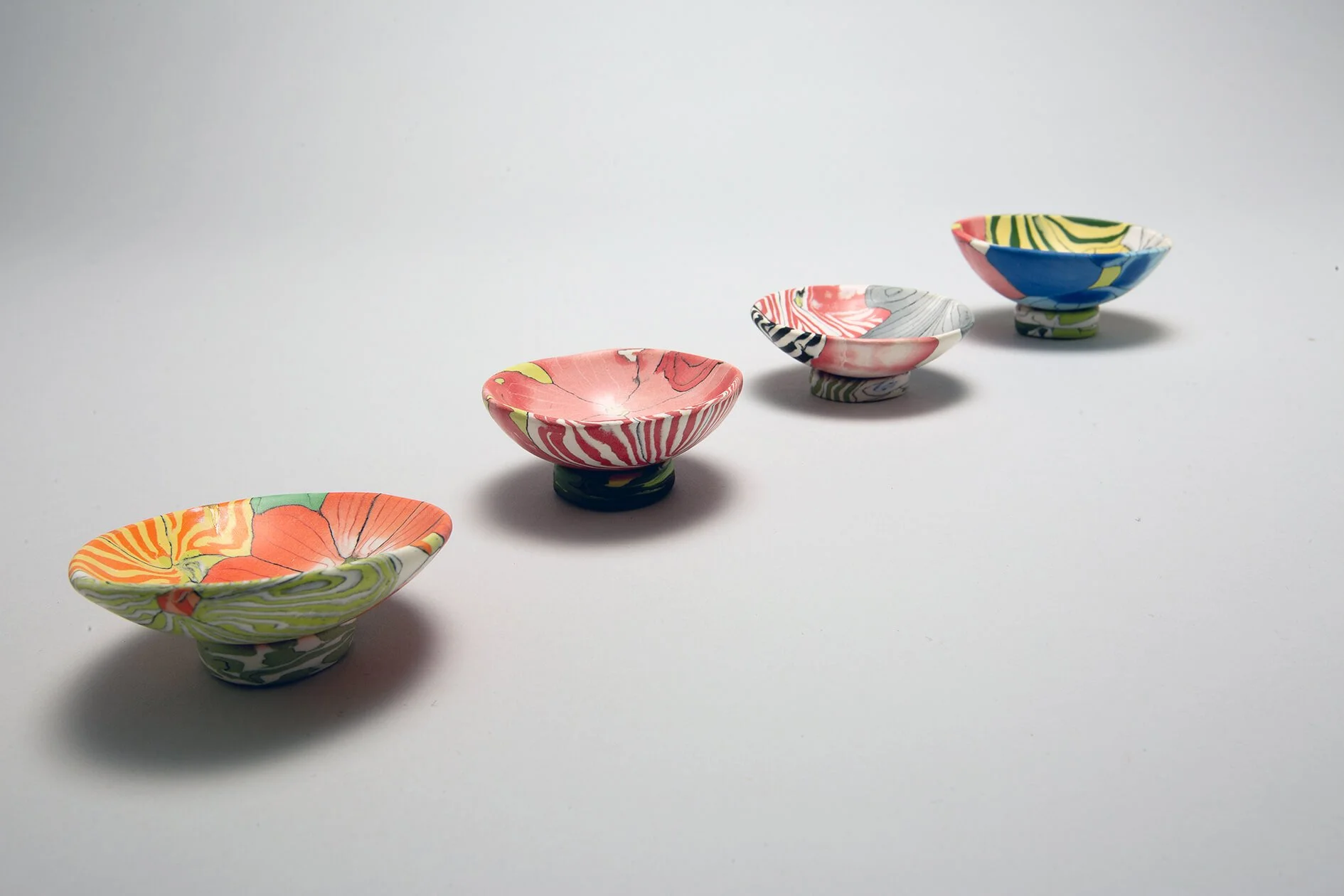 Small Nerikomi dishes with separate stands
 
 Coloured porcelain with gold Kintsugi detail 
 Various sizes 
 Sold 