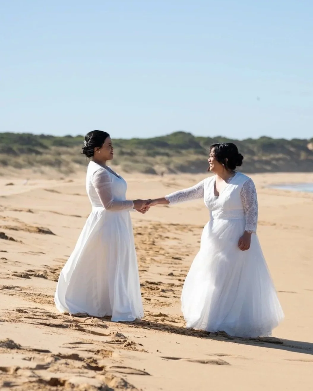 A black-and-white photo of a couple dressed in formal attire descending the steps of parliament house in Melbourne