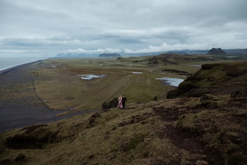 Newly engaged couple exploring Dyrhólaey after their Kvernufoss proposal