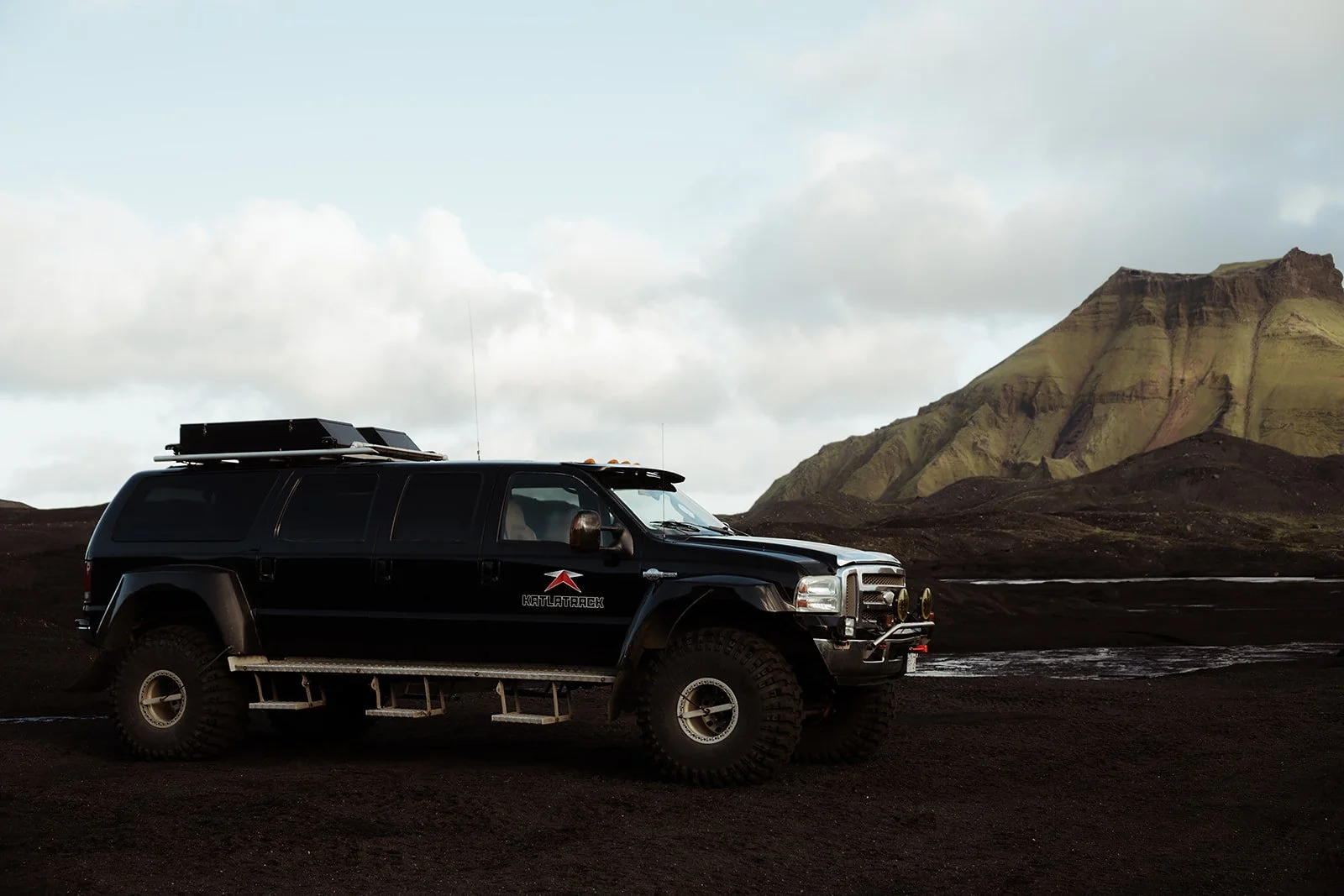 Couple travelling by Super Jeep to a Katla ice cave elopement near Vík Iceland