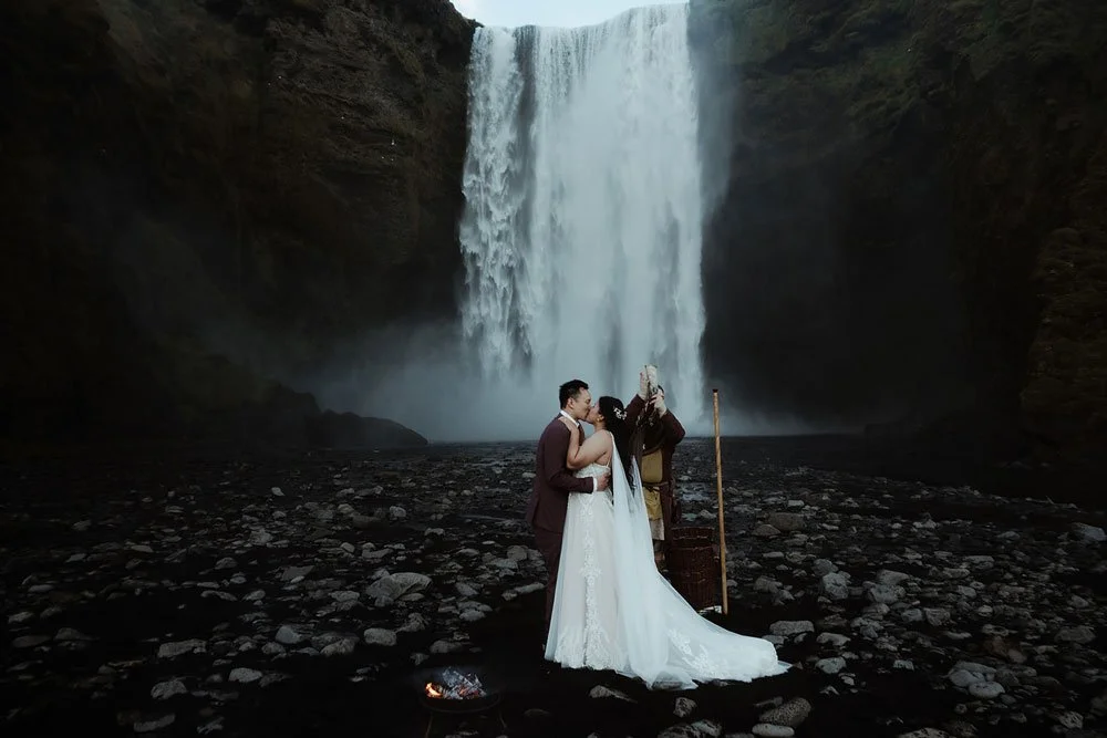 bride and groom getting married in front of Skogafoss waterfall