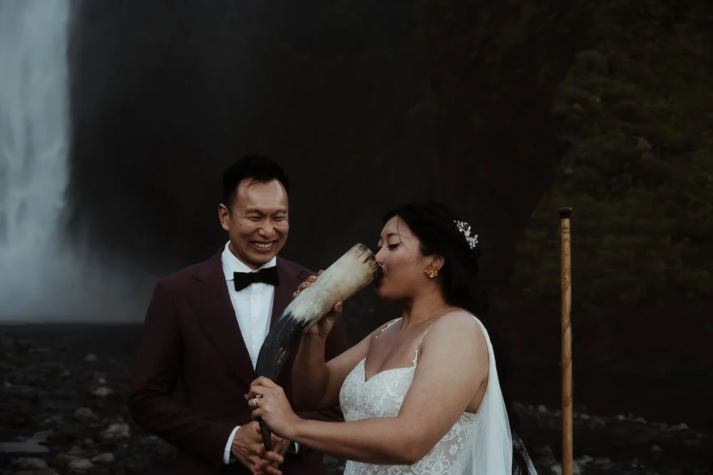 bride and groom getting married in front of Skogafoss waterfall