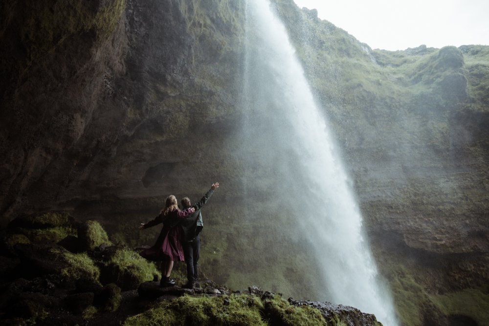 William and Kelsie celebrating their engagement beside Kvernufoss
