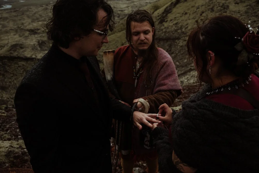 Chey and Joe exchanging rings during their Iceland Ásatrú wedding ceremony.