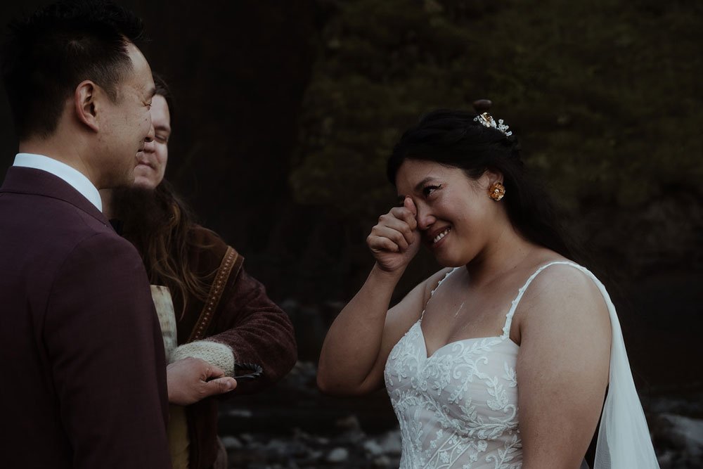 bride and groom getting married in front of Skogafoss waterfall