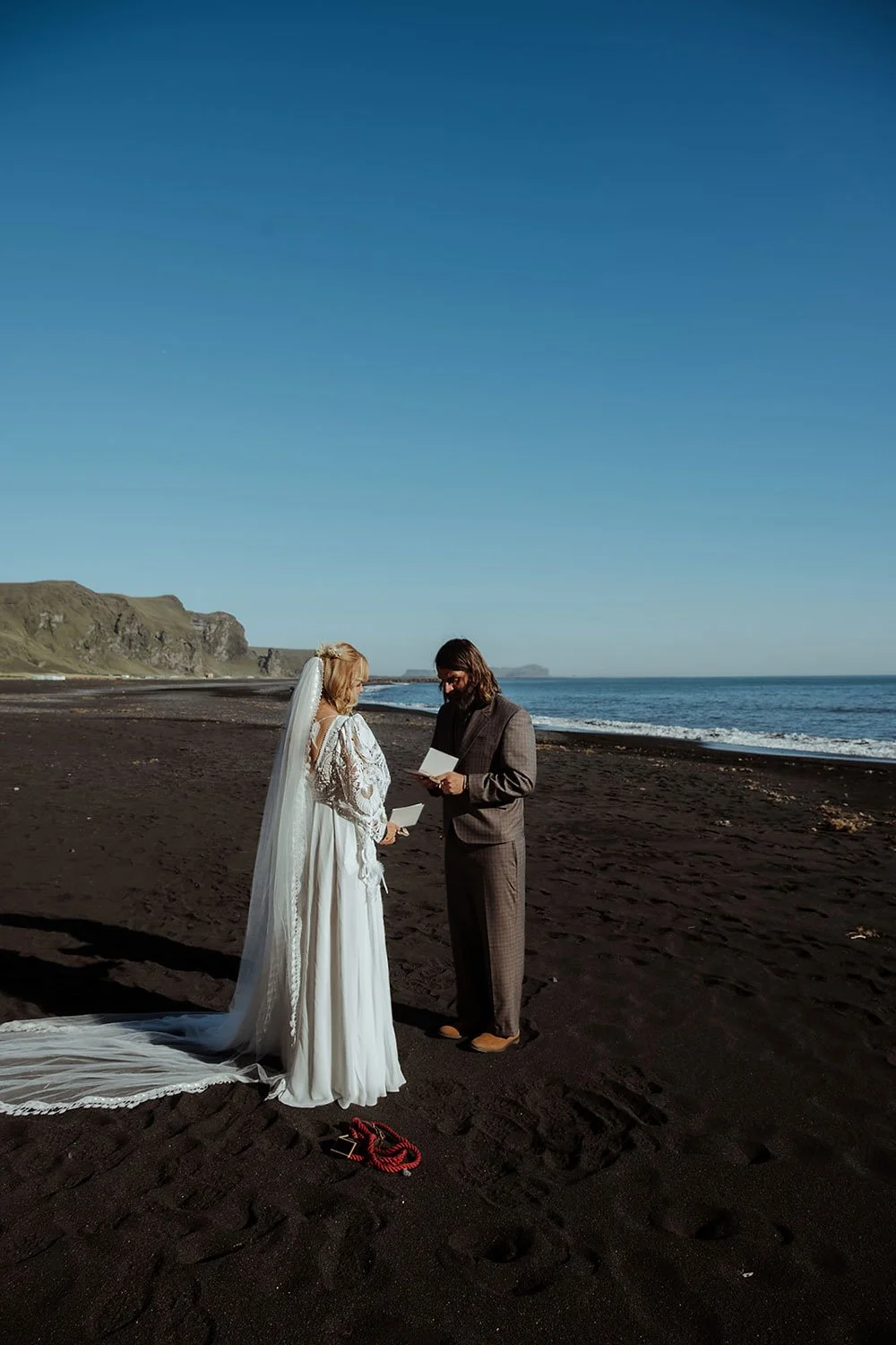 couple exchanging vows on black sand beach Iceland