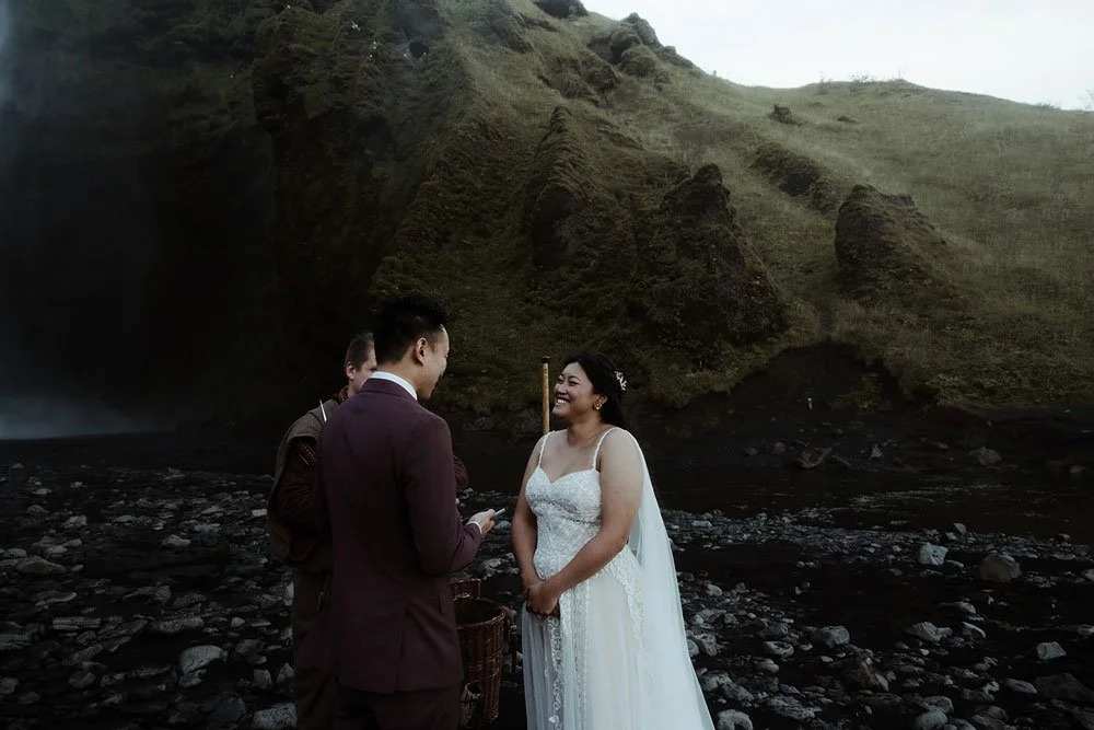 bride and groom getting married in front of Skogafoss waterfall