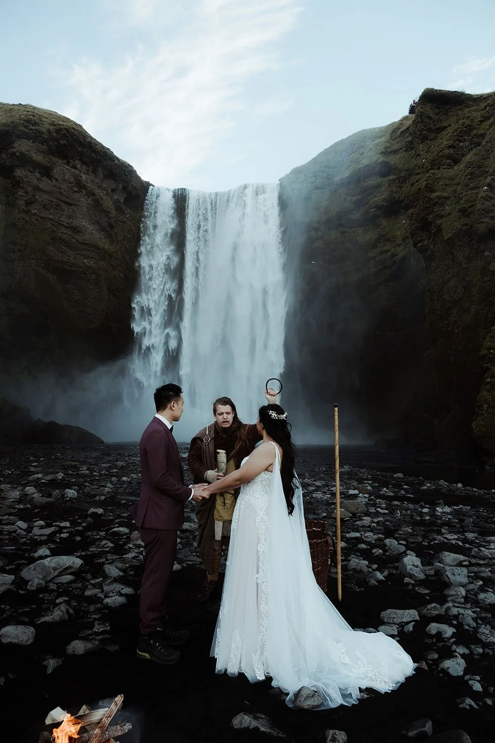 bride and groom getting married in front of Skogafoss waterfall