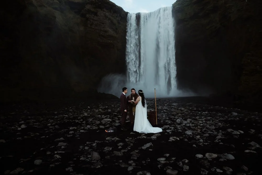 bride and groom getting married in front of Skogafoss waterfall