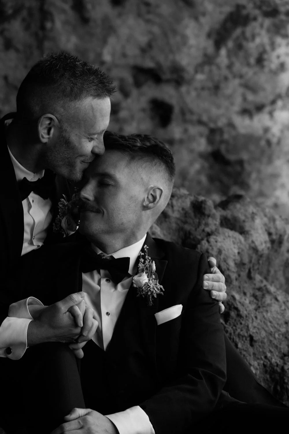 Two grooms share a quiet moment together during their intimate Iceland elopement.