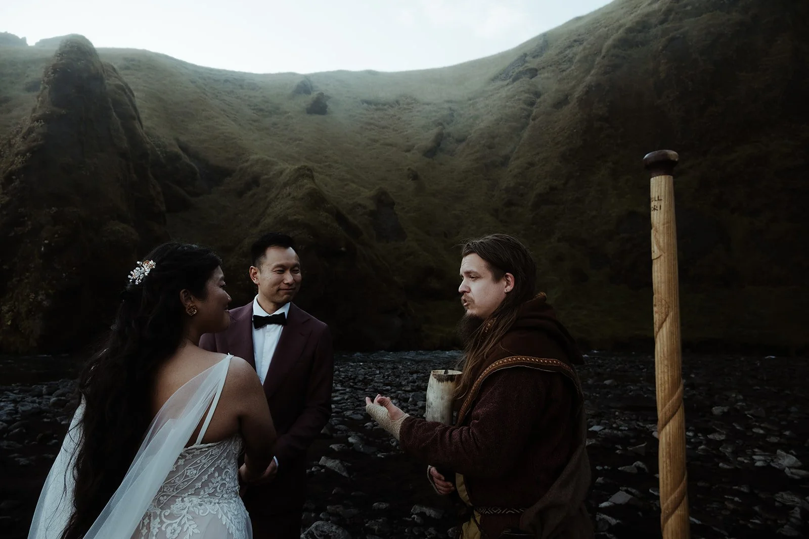 bride and groom getting married in front of Skogafoss waterfall