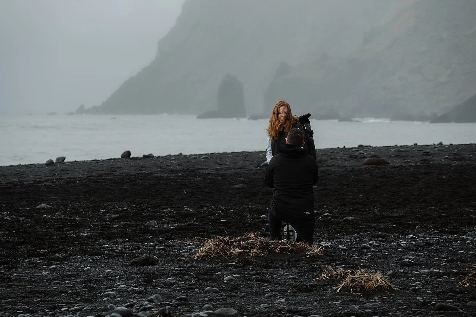 surprise engagement on black sand beach in South Iceland