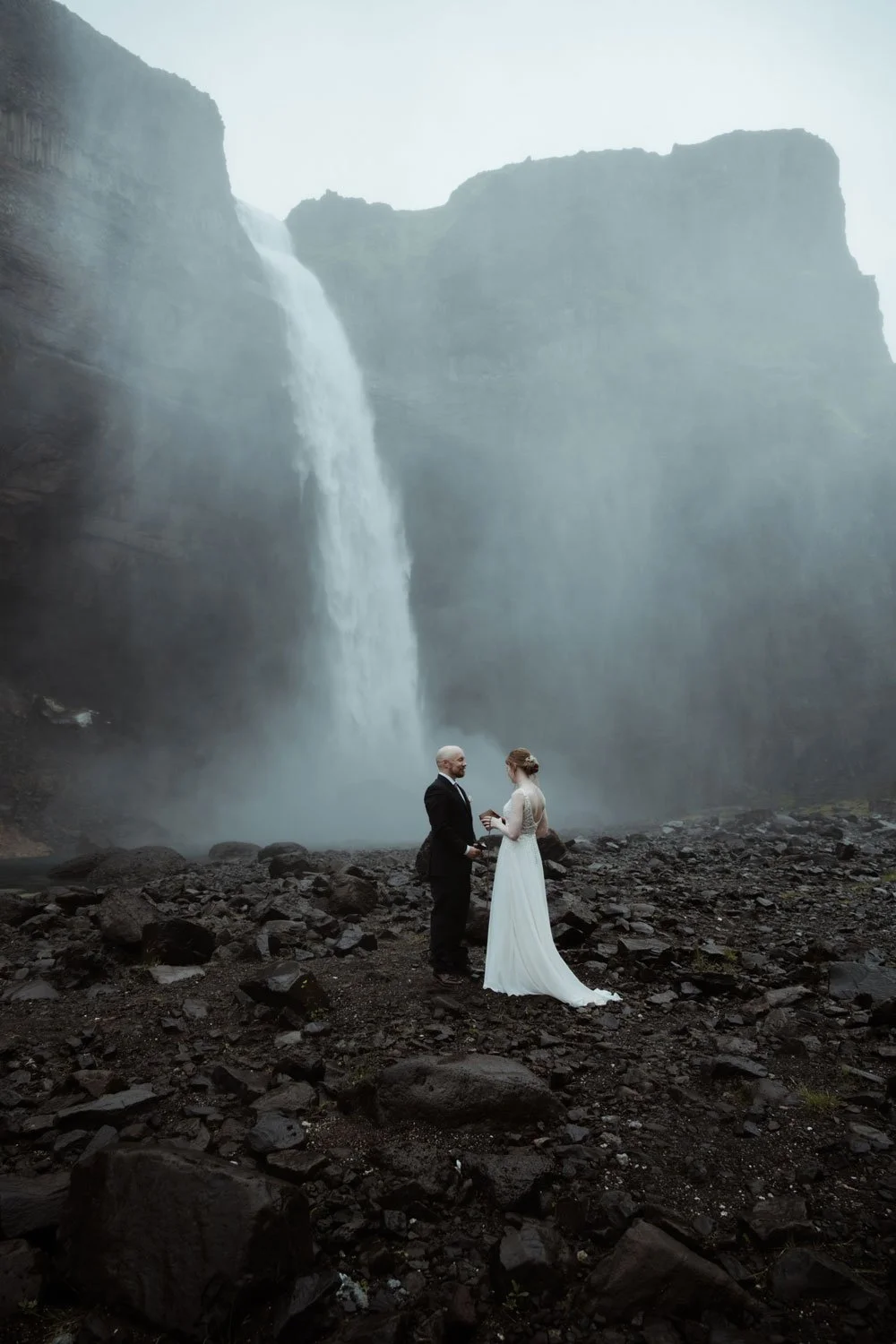 Wedding couple exchanging vows at Háifoss waterfall in Iceland