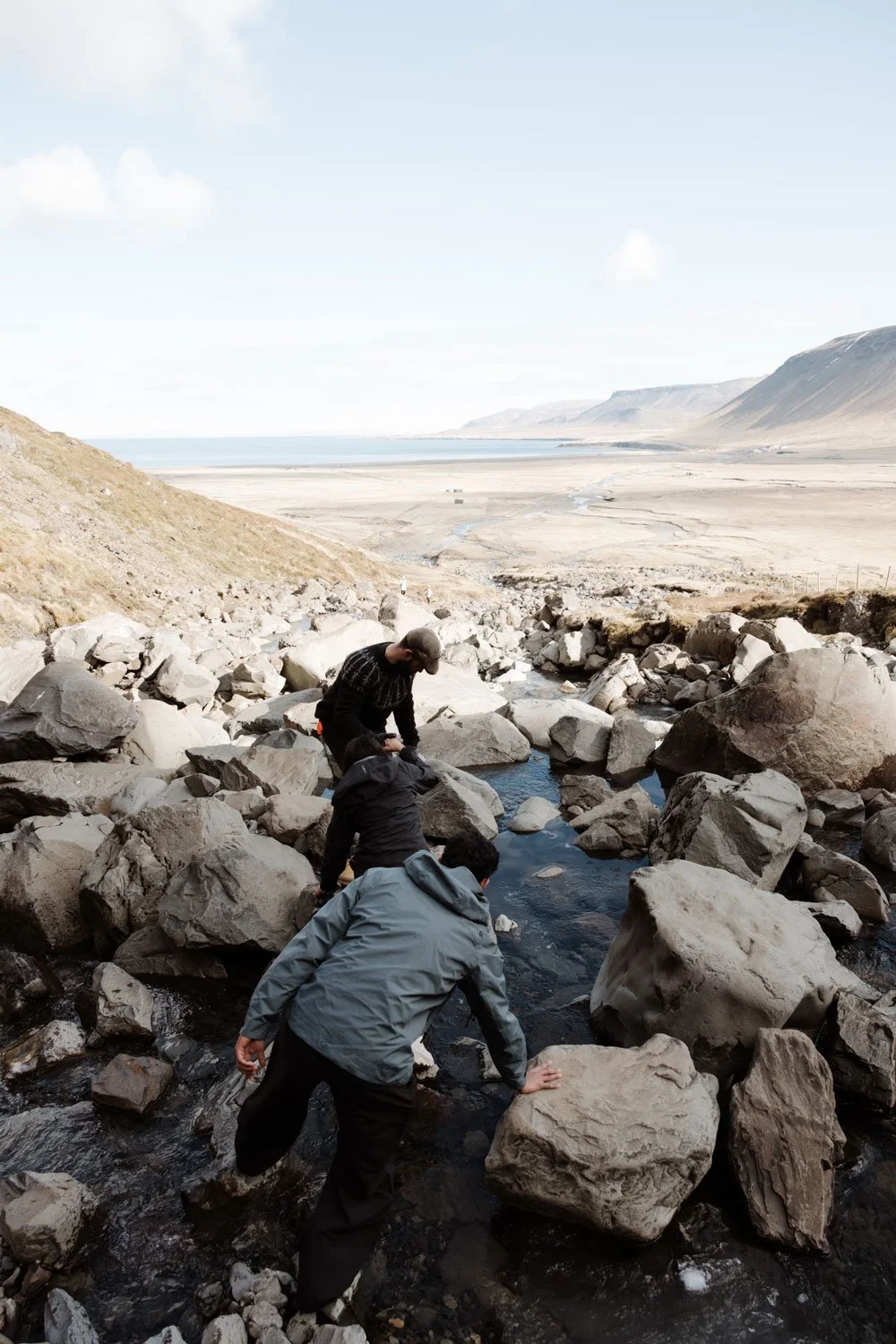 couple crossing river during Iceland proposal hike