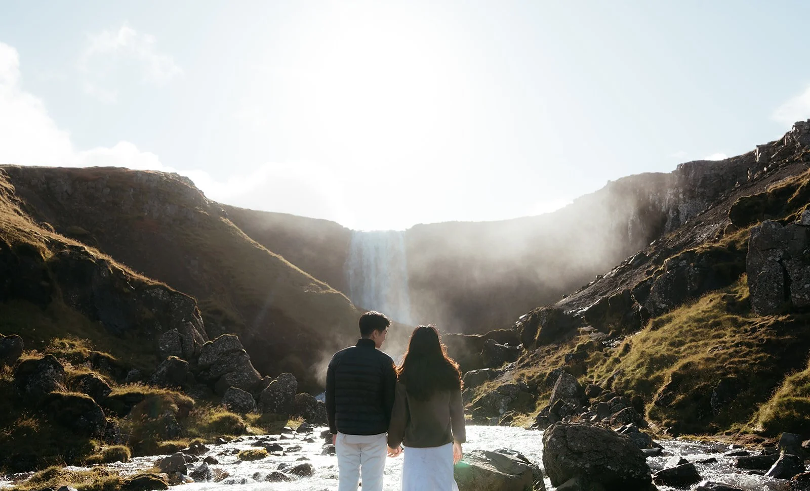 Newly engaged couple together beside Svöðufoss waterfall