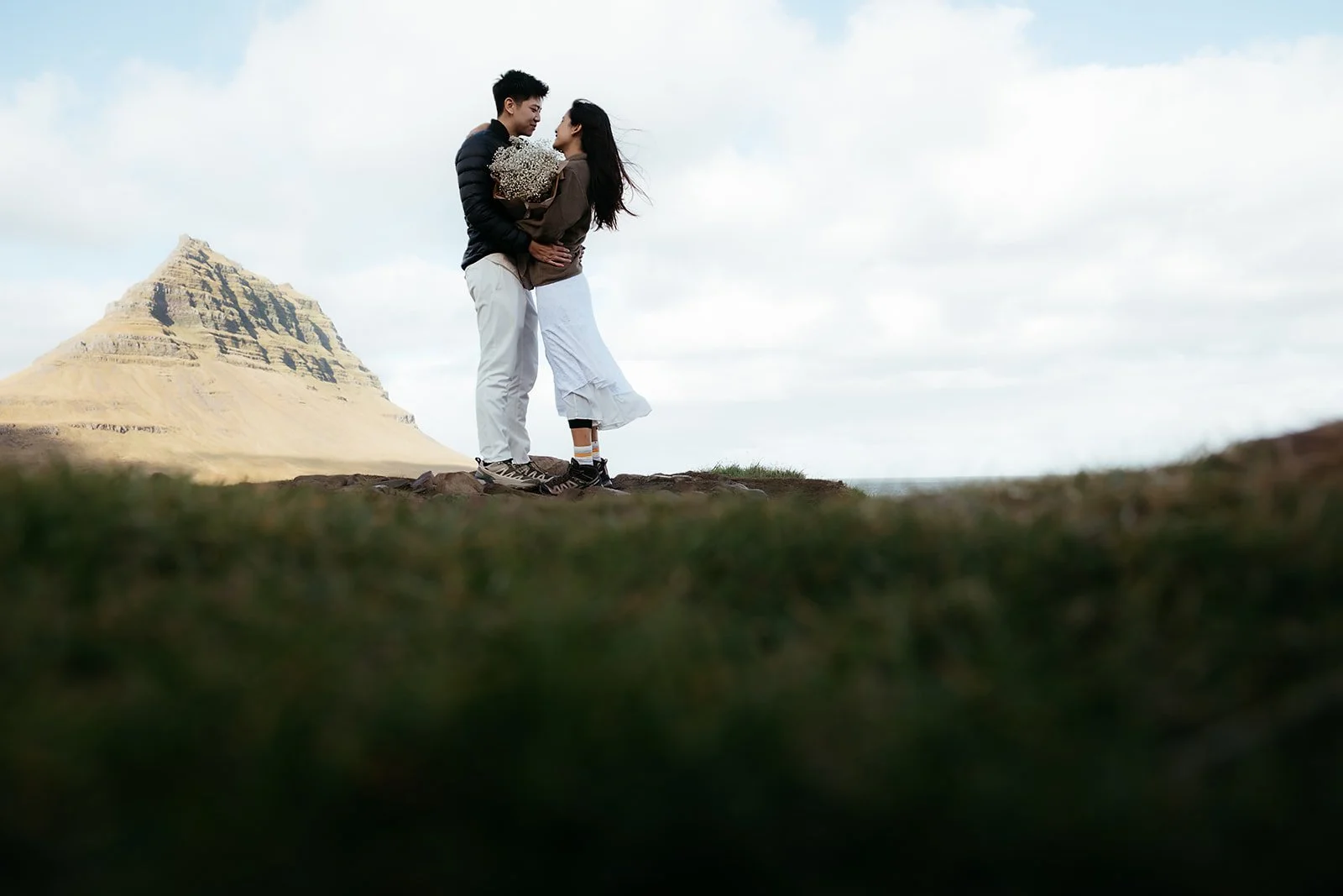 Engagement portrait of Luke and Euphrasia with Kirkjufell mountain behind them