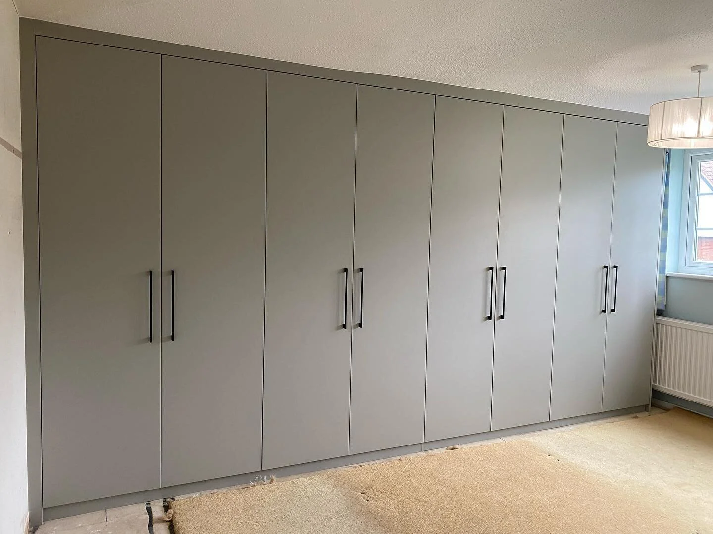 This huge wardrobe stretched across the whole bedroom wall. With a mixture of hanging, shelves and drawers. Finished in Pebble Grey. #Fitted #FittedFurniture #FittedWardrobes #FittedWardrobe #Bespoke #BespokeDesign #BespokeFurniture #BespokeCabinetry