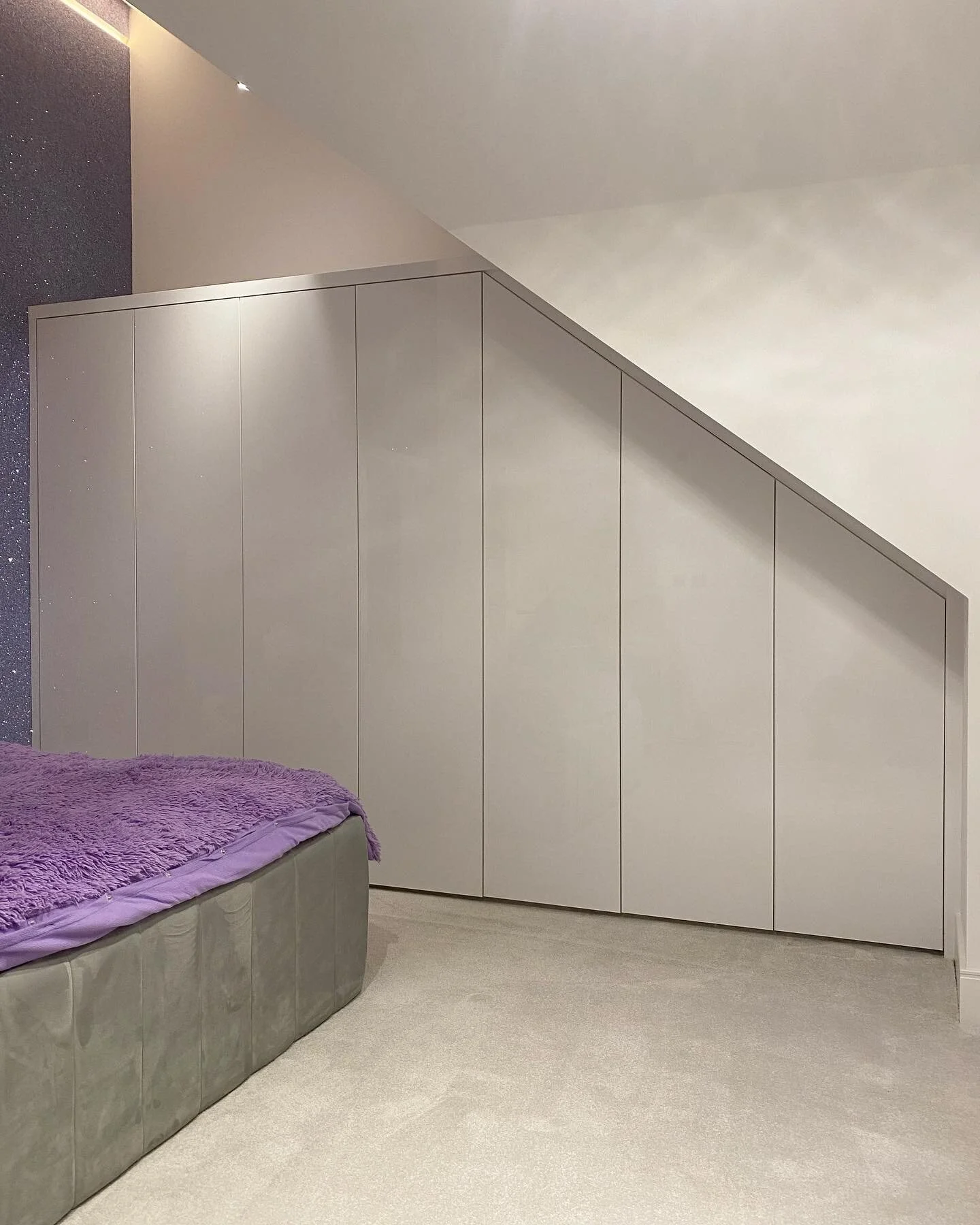 This 7 door wardrobe was fitted into the eaves of the roof, maximising the storage across the whole wall, with hanging, drawers and shelving. Finished in White High Gloss exterior and White interior.  #Fitted #FittedFurniture #Furniture #Bespoke #Bes