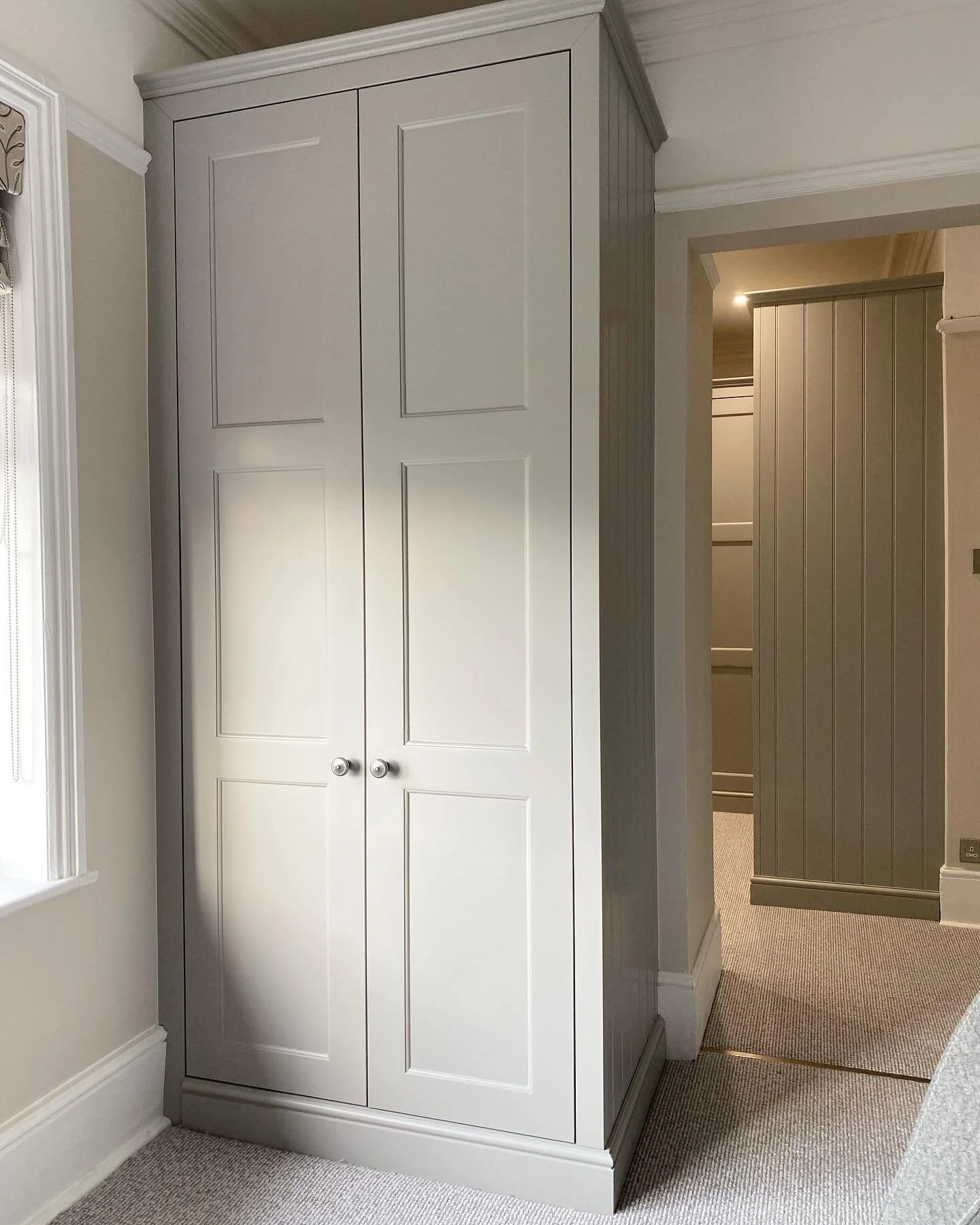 This beautiful dressing room and matching wardrobe at the entrance were designed to go with the traditional detailing of this house, by adding skirting boards and cornice around the wardrobes and split panel shaker doors. Spray finished is Farrow &am