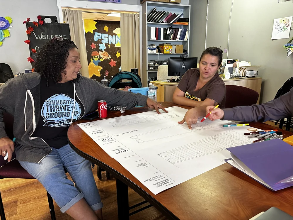   Adriana and Veronica look over plans for the new Urban Room.  