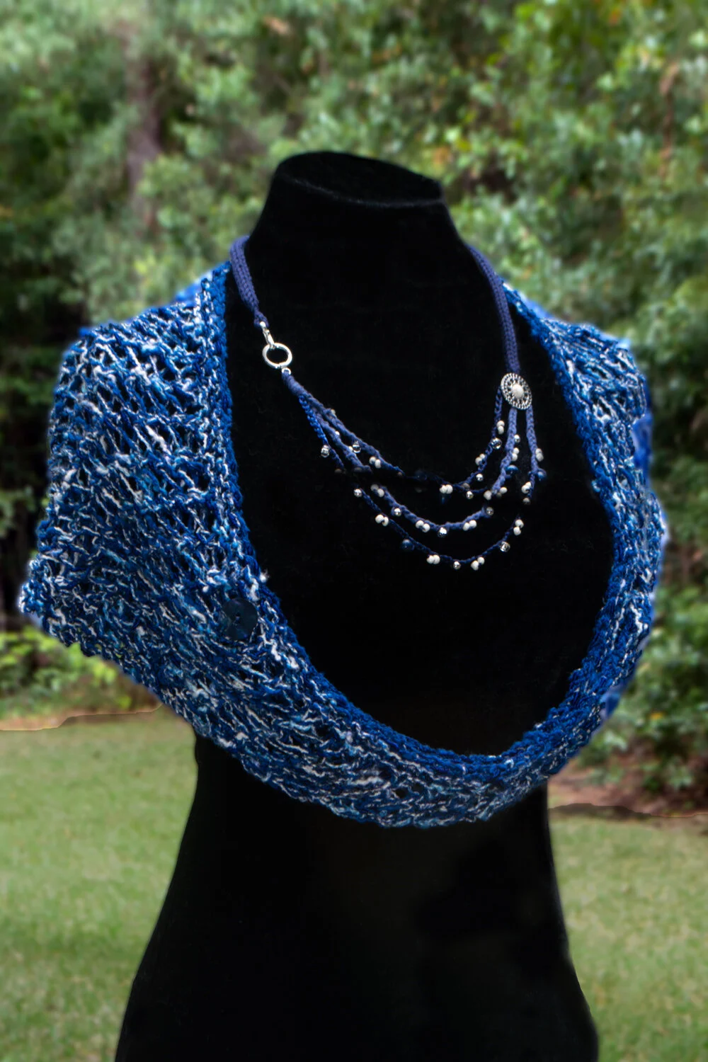 Blue Variegated 3-way Shawl, shown with a necklace