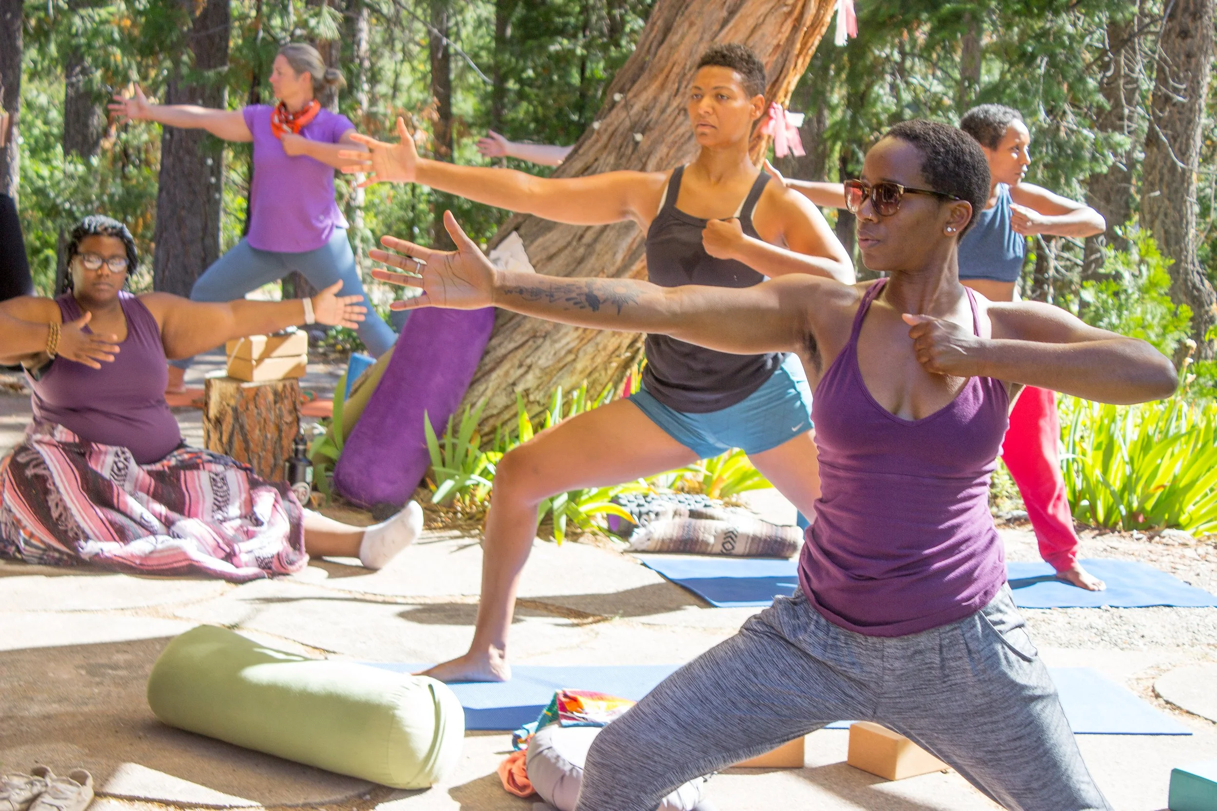 Women practicing yoga together outdoors at a Hestia Magic women's retreat in Mount Shasta, California