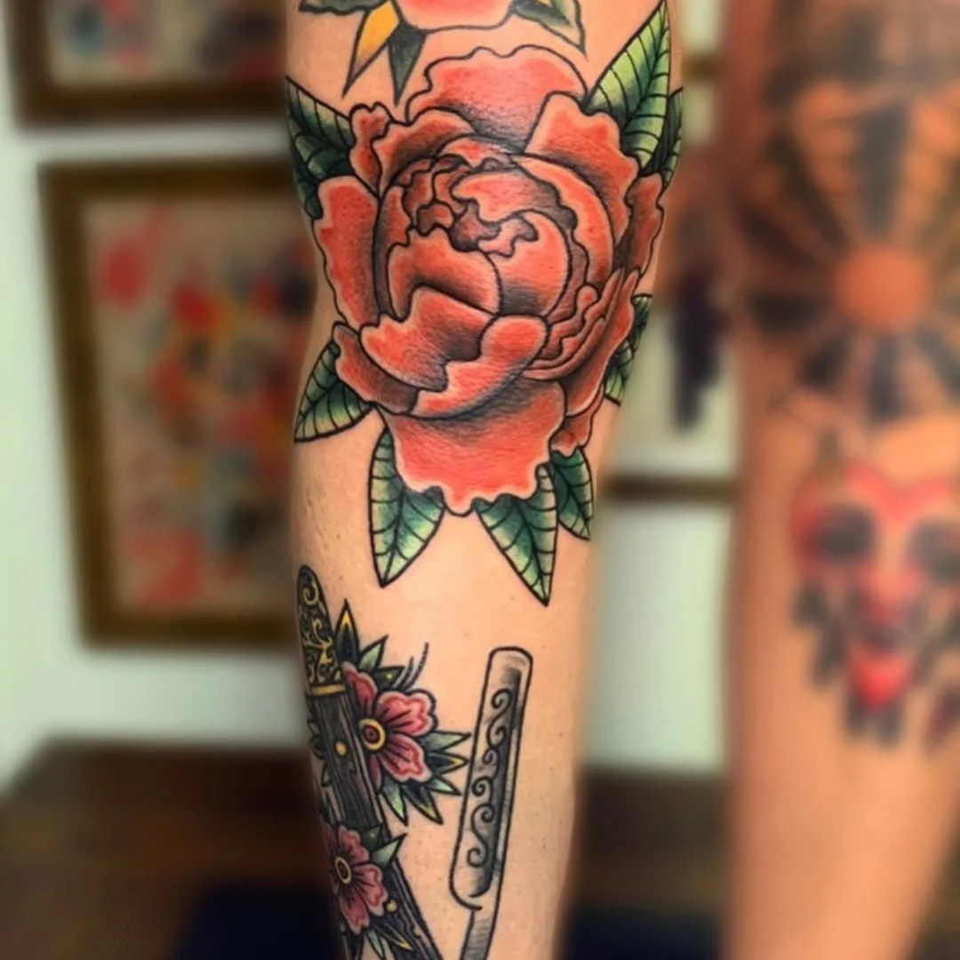 Zack tattooed this striking traditional style red rose, nestled perfectly on the kneecap. Featuring richly layered, saturated red petals framed by vibrant green leaves.

Whether you want a tough-as-nails placement like a knee ditch, a custom floral p