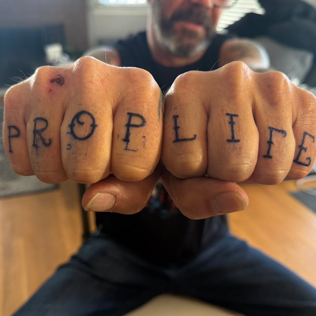 Kelly traveled across the country to zap a California family with a collection of killer tattoos! This incredible lineup of custom work features a powerful "prop life" inscription flowing across a pair of hands, a sweet teddy bear embraced 