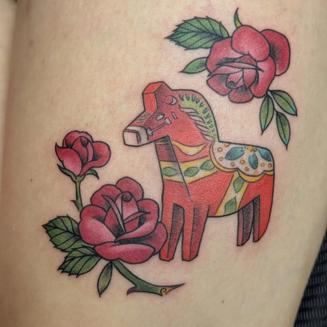 Bring on the bold color! 🪅🌹✨

Check out this incredible tattoo by Rachel from this past July! A bright and colorful pi&ntilde;ata framed by gorgeous roses! Deep, saturated reds and crisp, clean lines make it look like you could pick it right up and