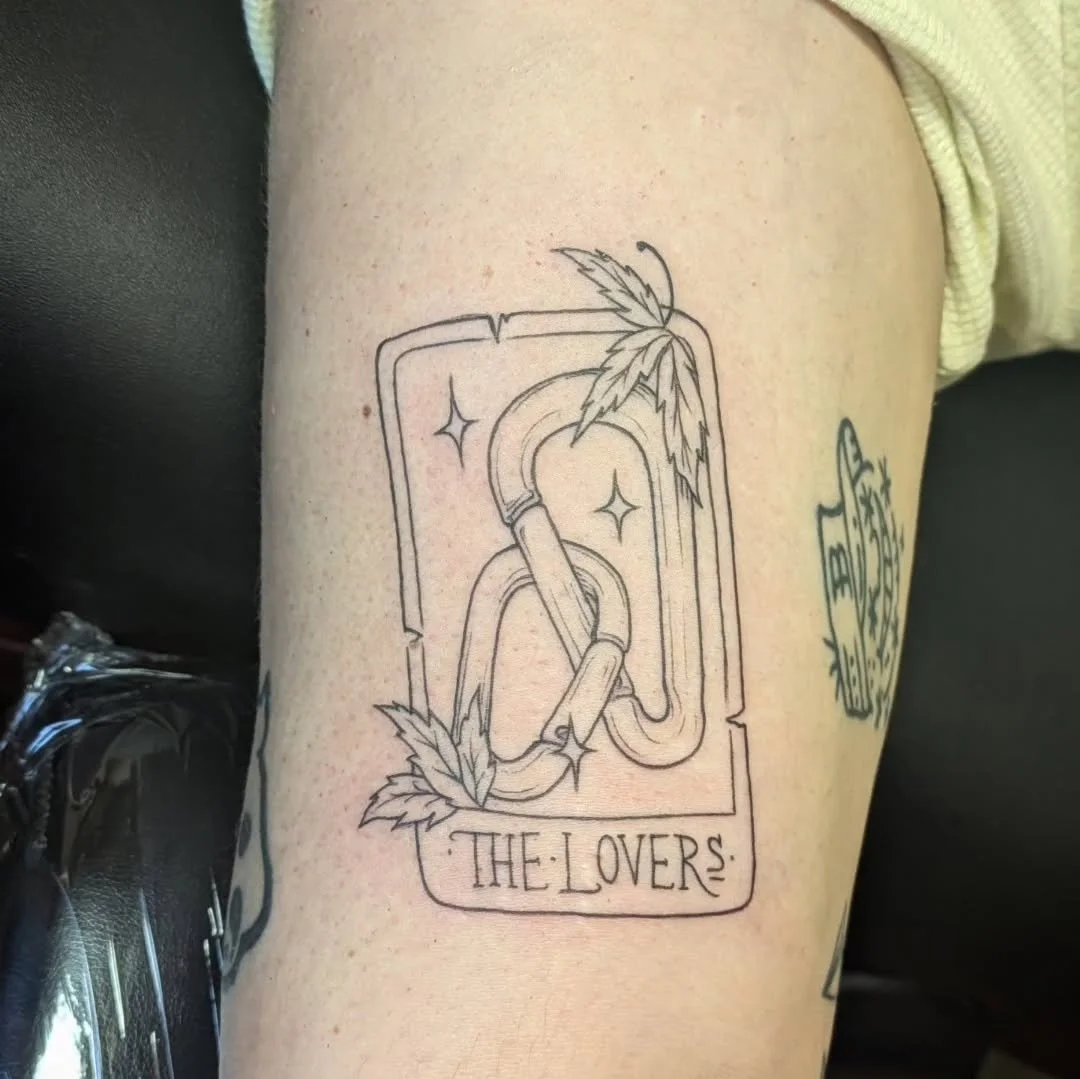 Check out this fine-line "The Lovers" tarot card zapped by Rachel! Featuring two interlocked carabiners adorned on opposing ends with finely detailed cannabis leaves, this work of art inked into the skin is not only beautiful, but represent