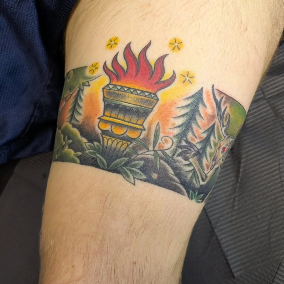 Rachel outdid herself with this stylized ceremonial torch! It's lighting up an area in the deep forest as an ancient, red eyed beast reaches out for its light and warmth. The rich color contrast, glowing flames, and detailed band design bring this my
