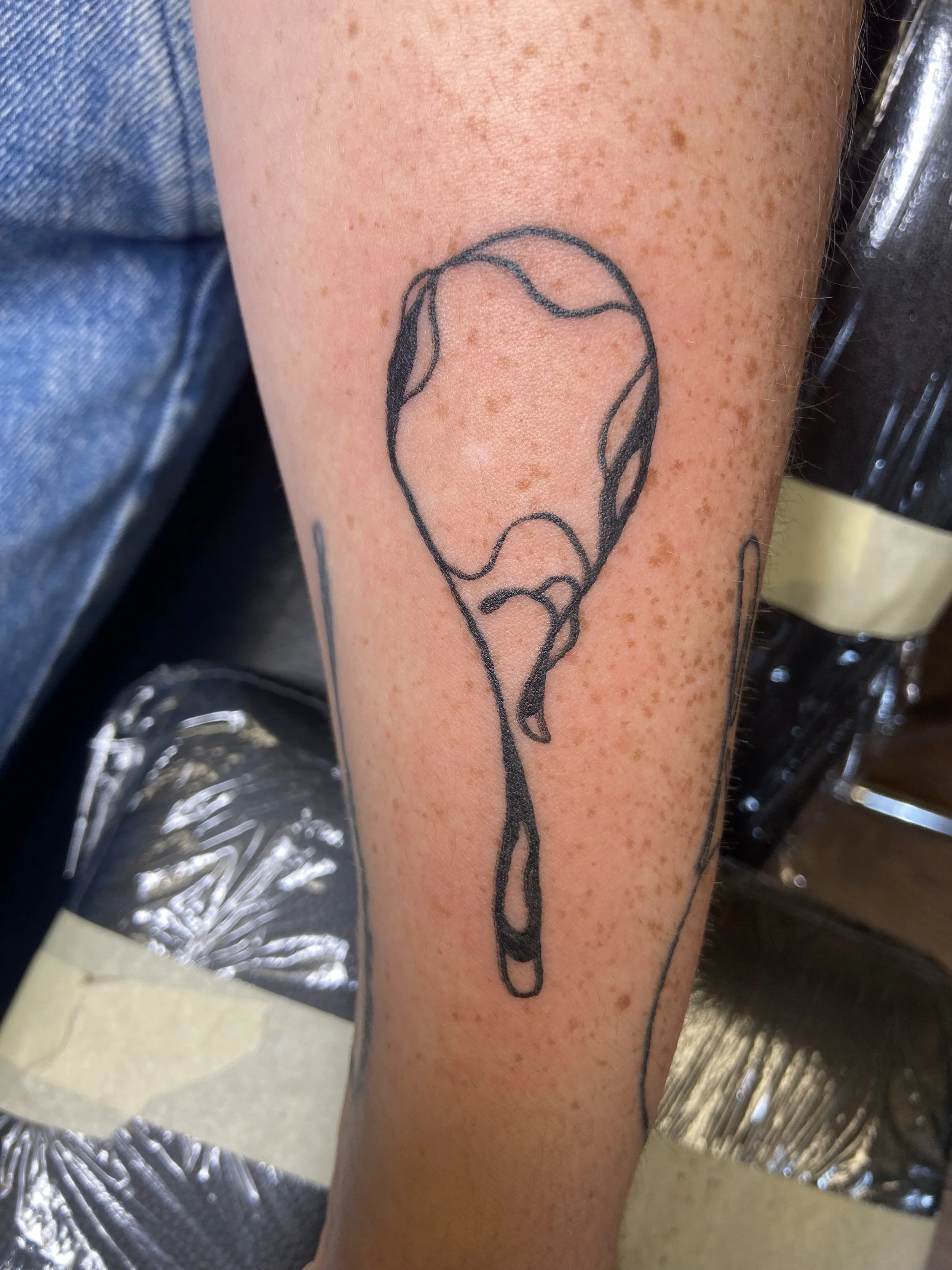 Black and white racket tattoo