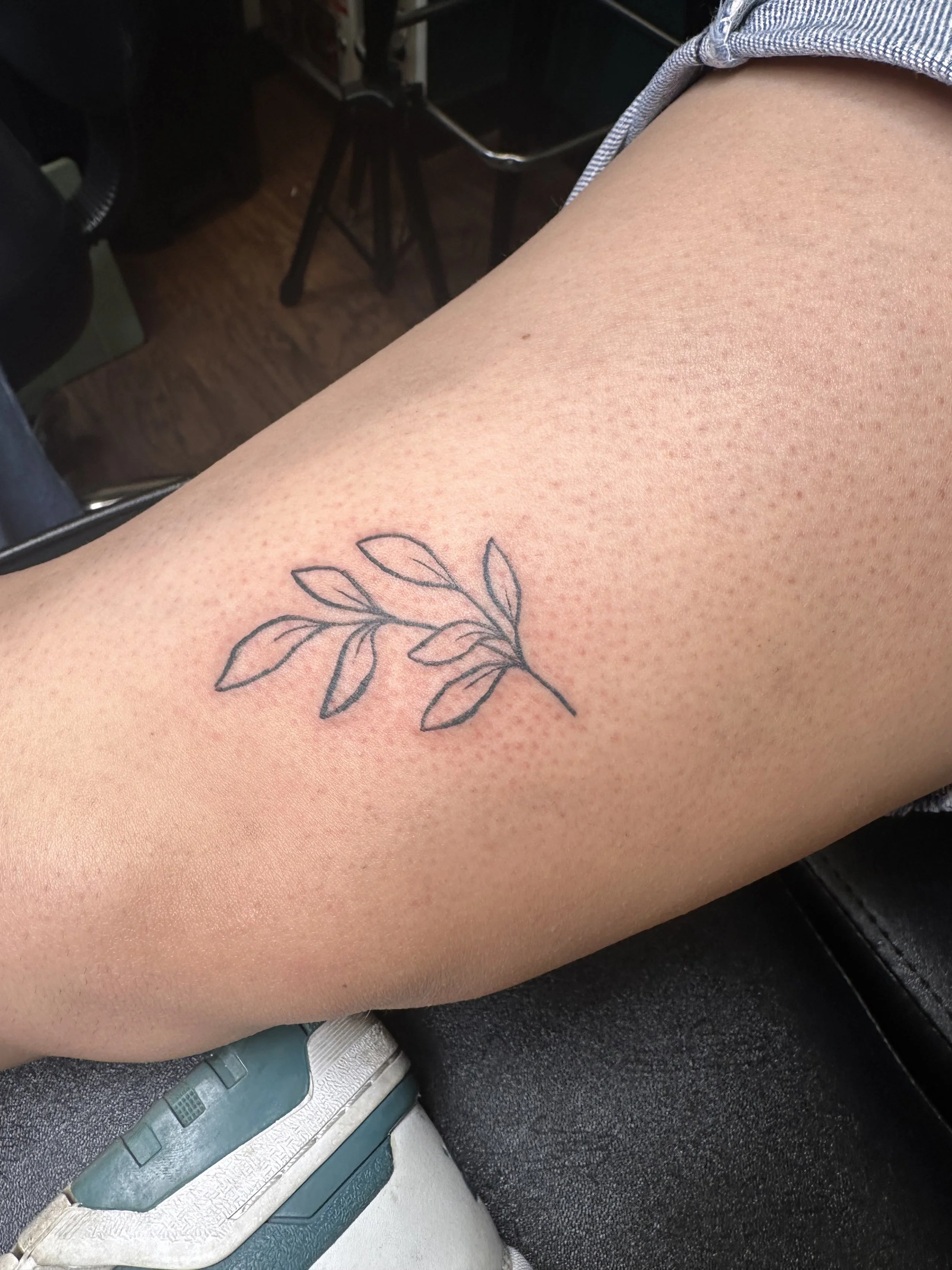 Small black and white branch tattoo