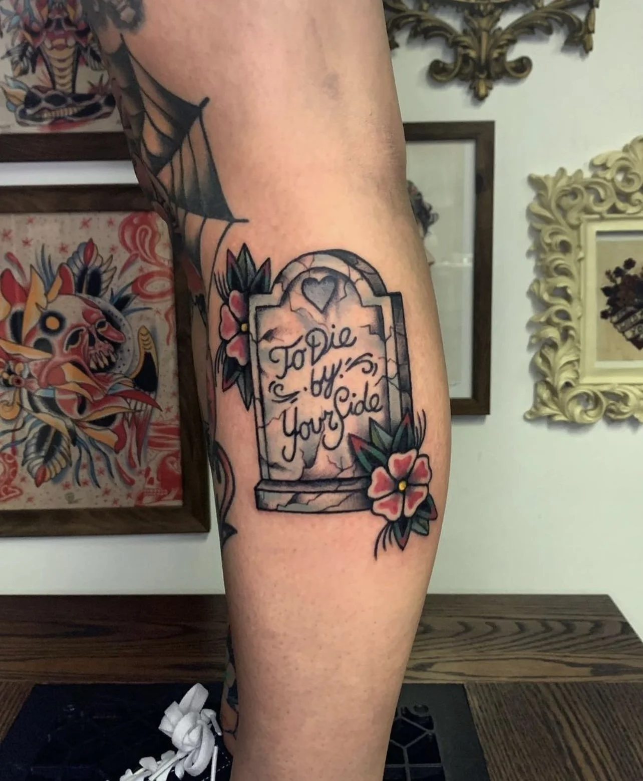 Blackwork tattoo of a headstone with epitaph.