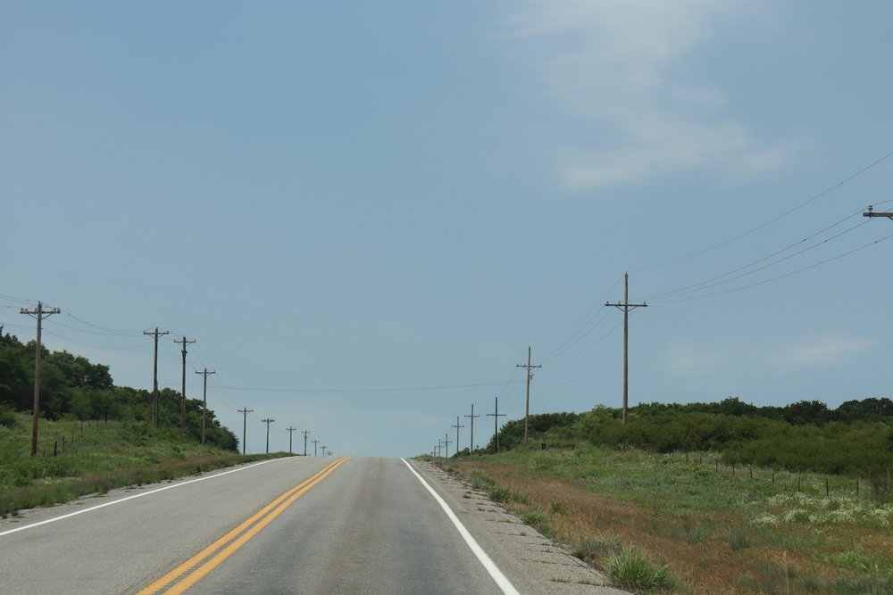 Long stretches of roads with flat grassland and endless telephone poles.