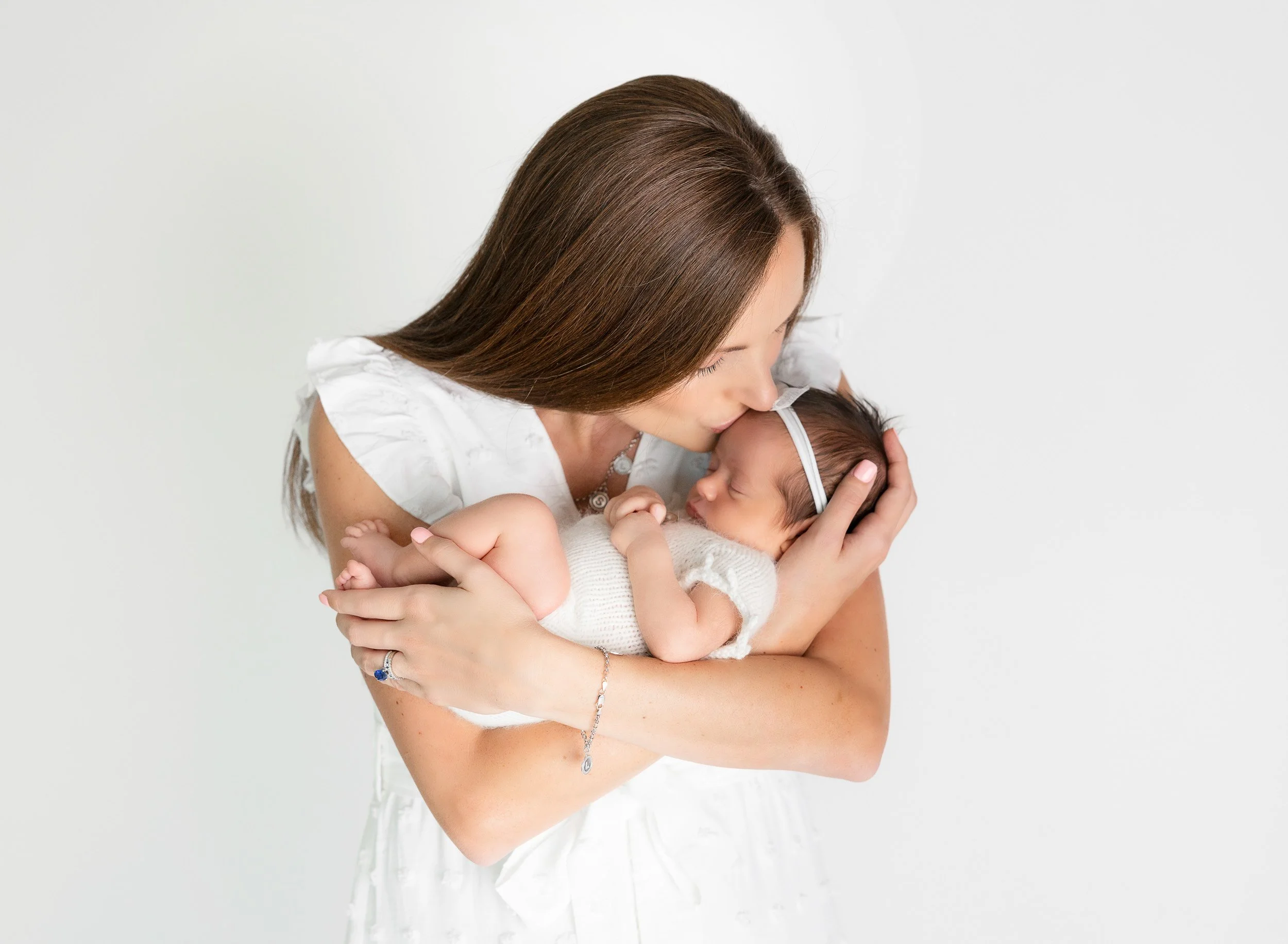 Beautiful newborn family photography in Tampa for growing families. Timeless, natural portraits of parents and their newborn baby in a warm, relaxed setting.