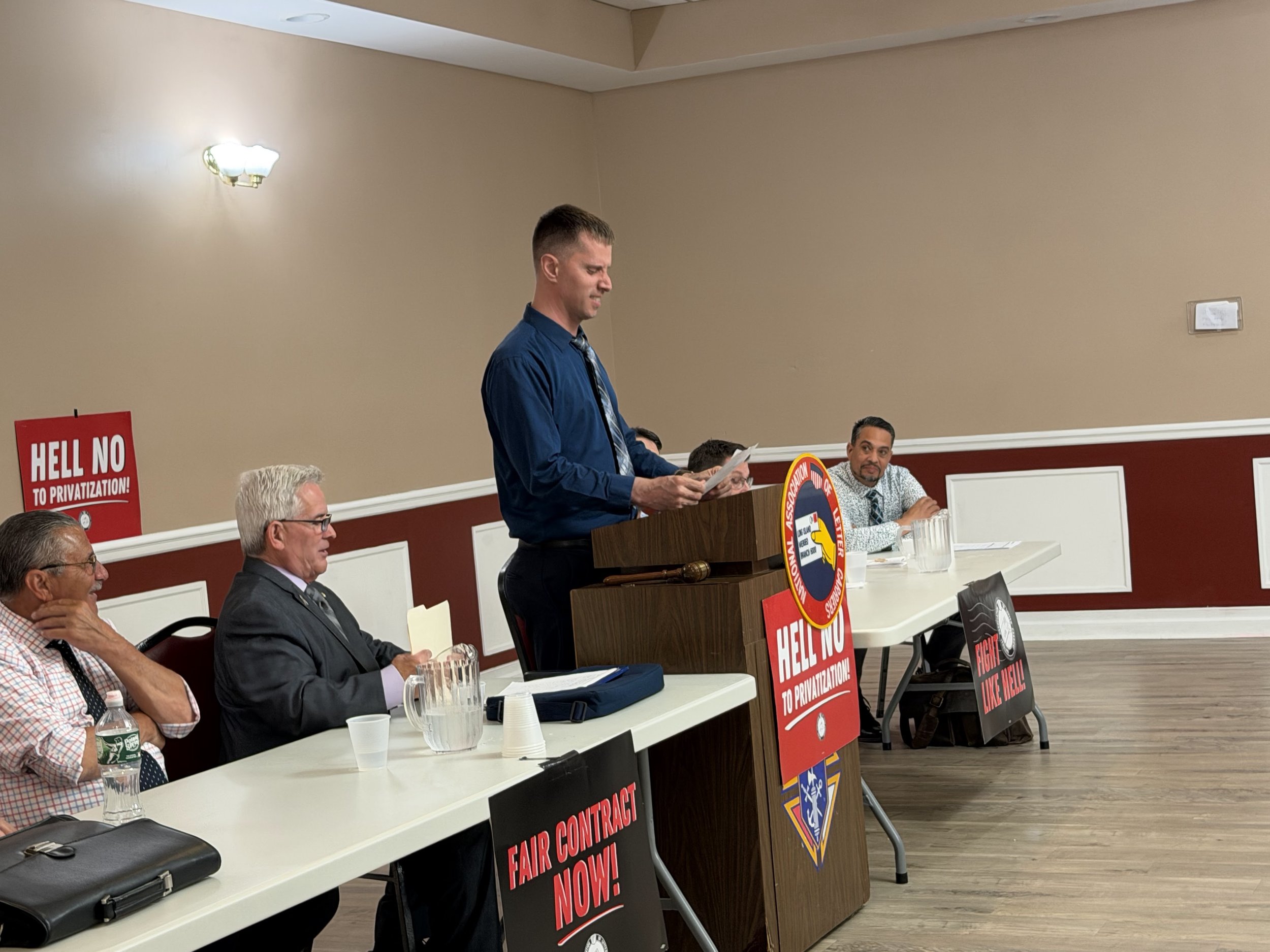 Treasurer Bill Rotunda gives the financial report.