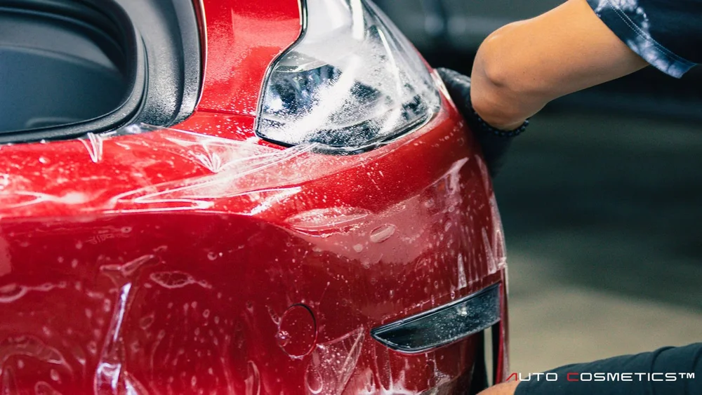 Technicians installing paint protection film on a vehicle at Auto Cosmetics in Chandler
