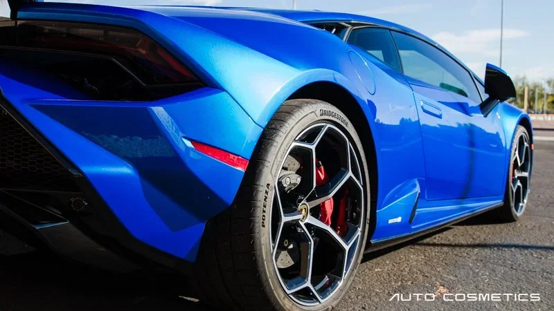 Paint protection film being applied to a blue Lamborghini at Auto Cosmetics in Chandler, Arizona